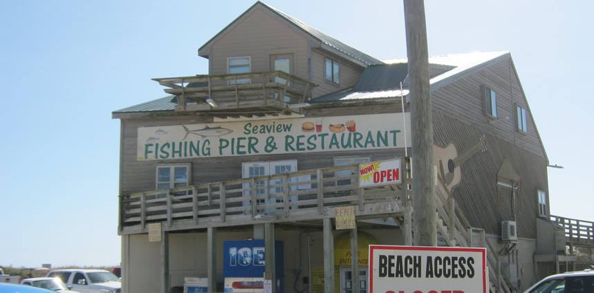 Image from Seaview Pier Restaurant's Facebook page a tall, wooden building with a sign that reads "Seaview Fishing Pier & Restaurant" in green text